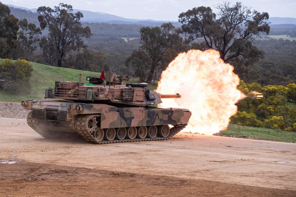 An Abrams tank fires during an Army firepower demonstration for guests and families at the Puckapunyal Range in Victoria.