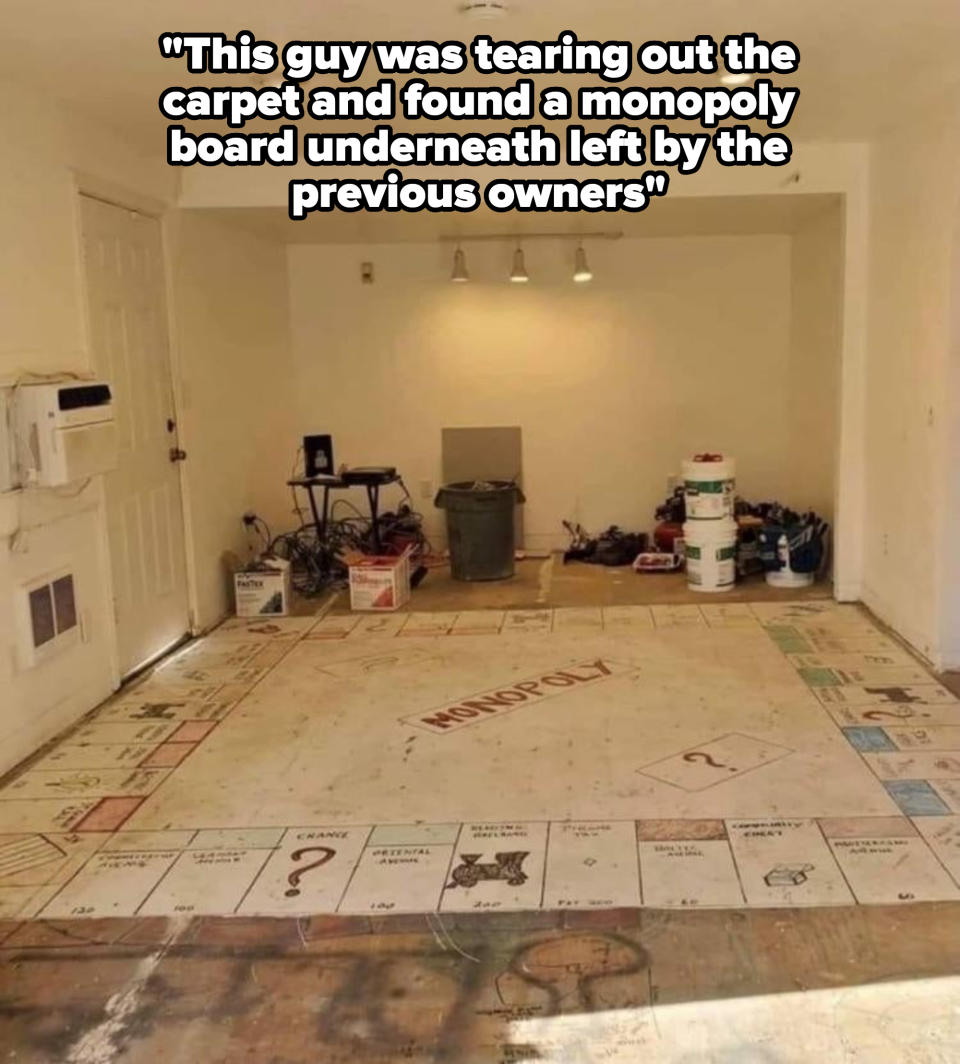 Garage converted into Monopoly themed room. The floor resembles a Monopoly board with squares and property names, and various boxes and paint pots are scattered around it