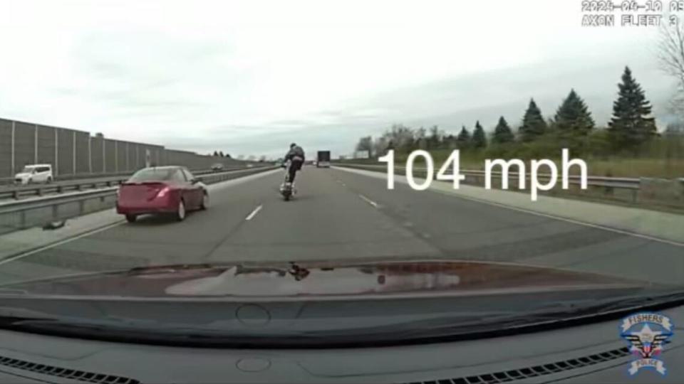 Man stands on motorcycle seat while riding 104 MPH