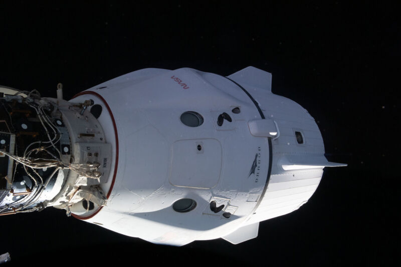 A Crew Dragon spacecraft docks with the International Space Station in 2022. The portion of the spacecraft on the left is the pressure capsule, while the rear portion, on the right, is the trunk.