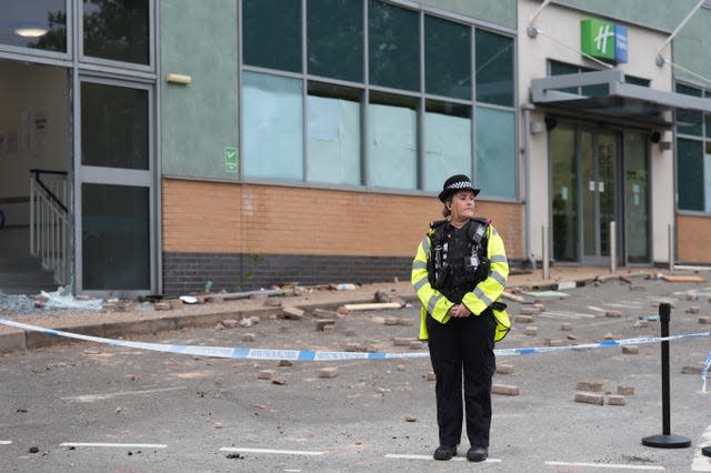 Police at the Holiday Inn Express in Tamworth after a crowd attacked it on Sunday