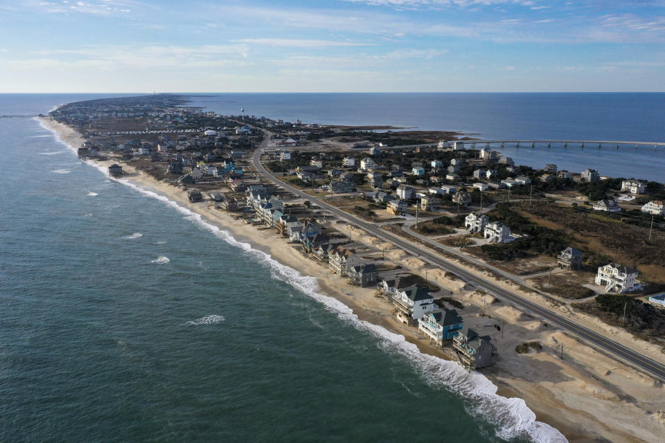 In 2023, ocean waves slowly erode the beach on the Outer Banks. 