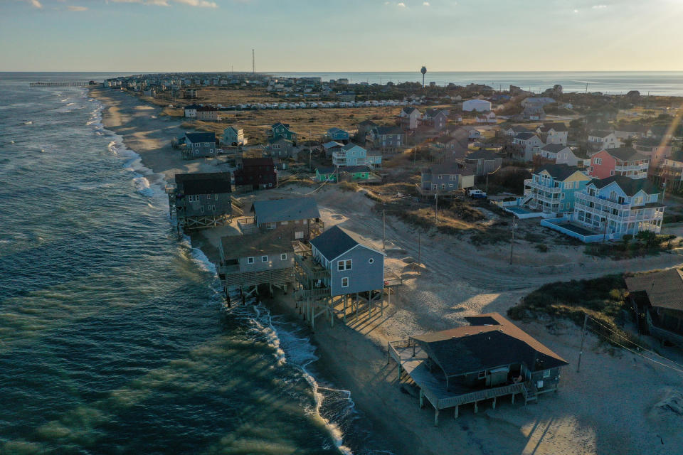 The beachfront home in Rodanthe, NC, pictured below right in January 2023, was swept away by Atlantic Ocean waves in March 2023. 