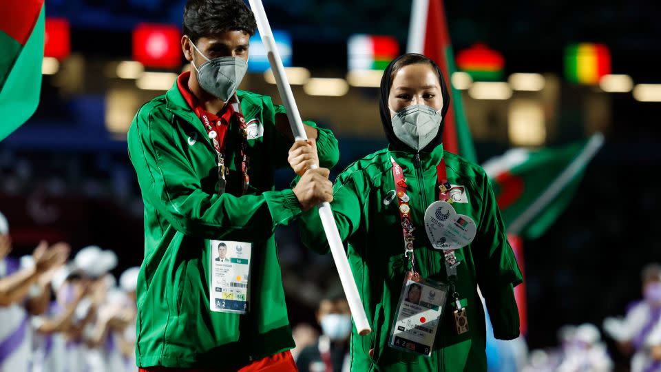 Hossain Rasouli (left) and Zakia Khudadadi carry the Afghan flag during the closing ceremony of the Tokyo Paralympic Games. - Issei Kato/Reuters