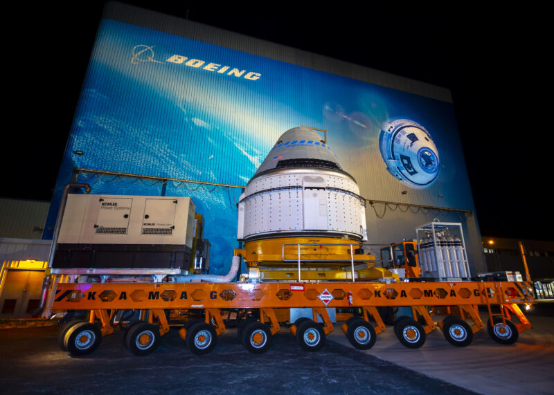 A Starliner spacecraft leaves Boeing's Spacecraft Processing Facility ahead of the program's first orbital test flight in 2019.