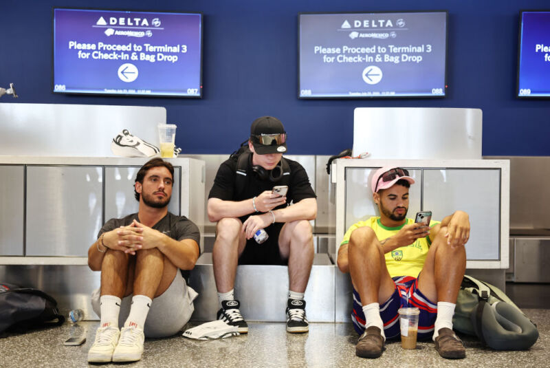 LOS ANGELES, CALIFORNIA - JULY 23: Travelers from France wait for their delayed flight on the check-in floor of the Delta Air Lines terminal at Los Angeles International Airport (LAX) on July 23, 2024 in Los Angeles, California.