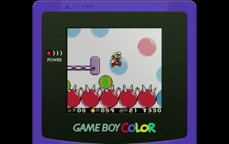 Super Mario Land 2 in color, featuring Mario jumping over spiky balls.