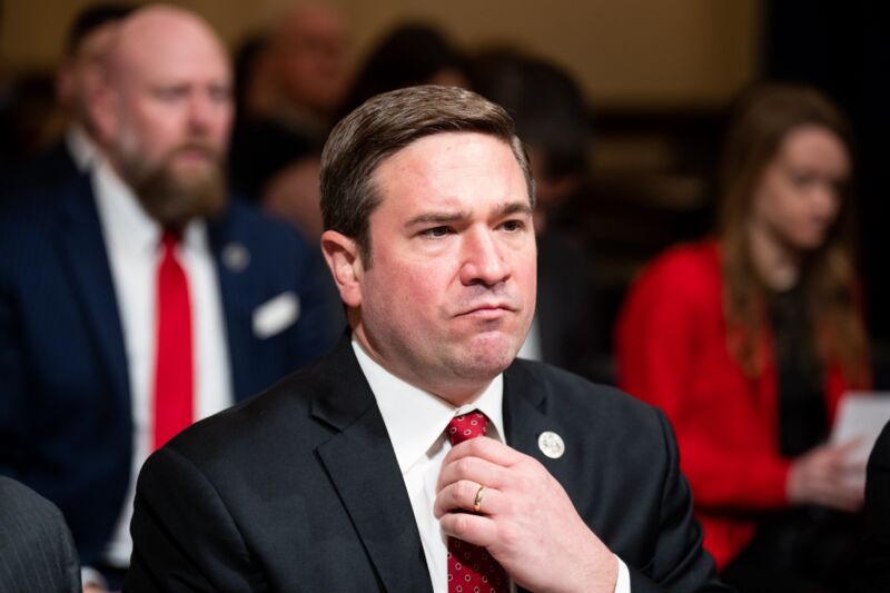 Missouri Attorney General Andrew Bailey adjusts his tie in a congressional hearing room