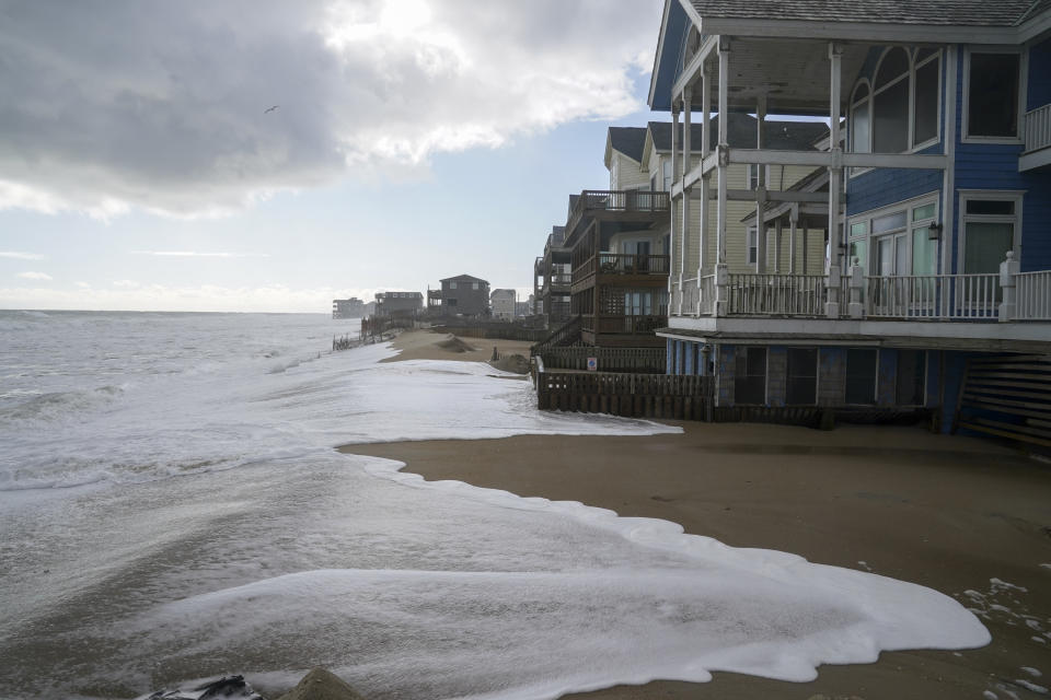 Ocean waves erode the beach behind 12 beachfront homes on Seagull Street on North Carolina's Outer Banks in 2022.