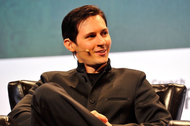 Telegram CEO Pavel Durov sits on stage and speaks at a conference.