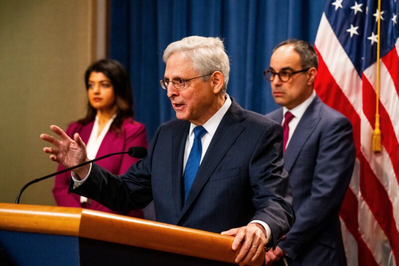 U.S. Attorney General Merrick Garland speaks at a press conference while standing behind a lectern.