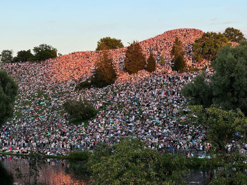 Thousands of fans gather on a hill outside Munich's Olympiaberg stadium to catch a glimpse of Taylor Swift's show last month