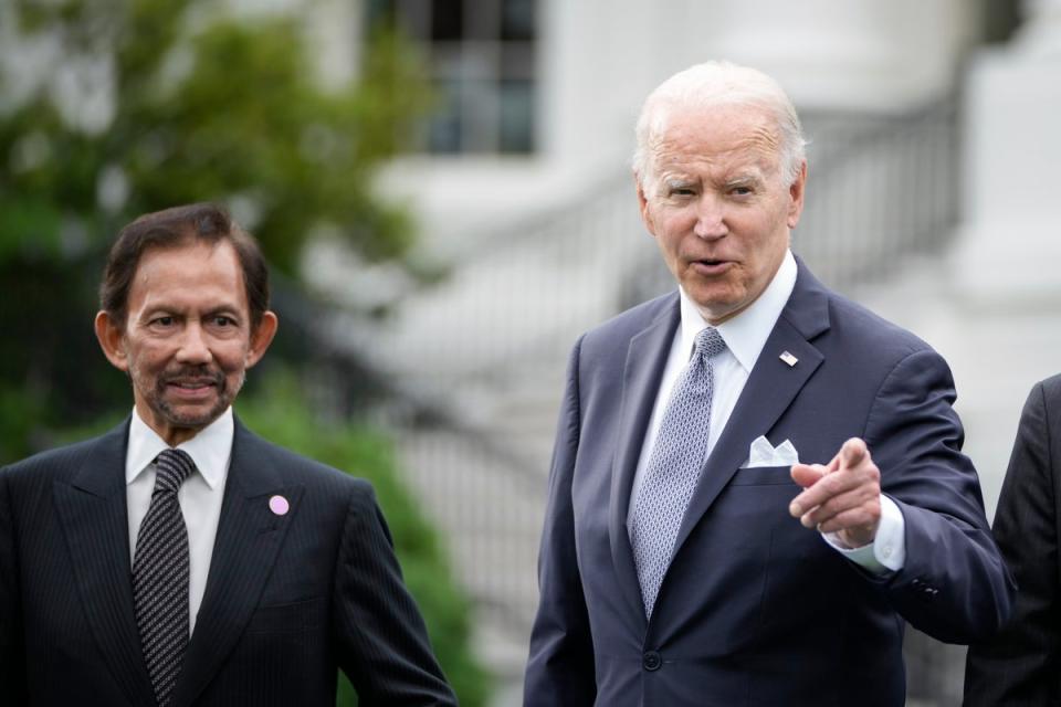 Sultan of Brunei Haji Hassanal Bolkiah looks on as US President Joe Biden responds to a question from a reporter during a family photo ahead of the US-ASEAN Special Summit on the South Lawn of the White House on May 12, 2022 in Washington, DC (Getty Images)