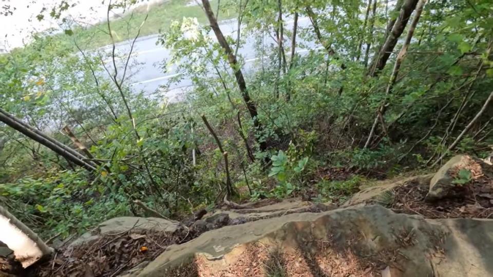 View from a cliff toward Exit 49 of Interstate 75 in Southern Kentucky. From the spot where Fred and Sheila McCoy say they shot Joseph Couch at 12 vehicles on September 7, 2024. In the video from the couple's YouTube page, Fred estimates the drop was likely 200-300 feet.