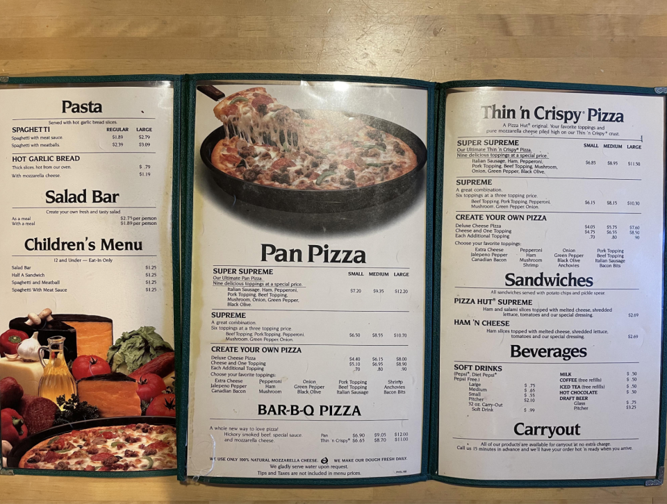 The image shows a restaurant menu with pasta, salad bar, children's menu, pan pizza, thin and crispy pizza, sandwiches, drinks and take-away options