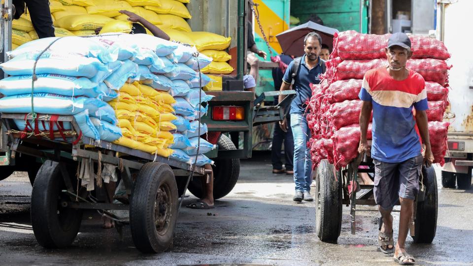 Handcart pullers at work at a wholesale market in the commercial center of Colombo, Sri Lanka, September 13, 2024. 