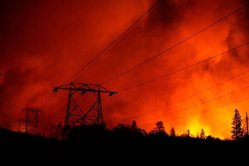 Power lines are seen in silhouette as the Creek Fire approaches the Shaver Springs neighborhood on Tollhouse Road in Auberry, California, on Tuesday, September 8, 2020.