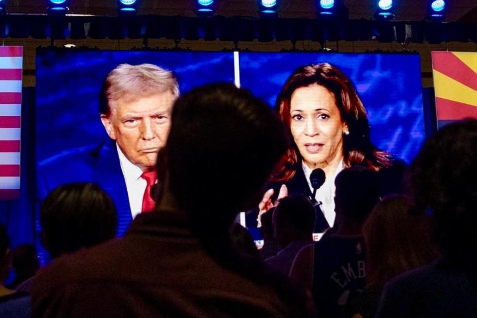 People at the Mesa Convention Center in Mesa, Arizona, watch a debate between former President Donald J. Trump and Vice President Kamala Harris on September 10, 2024.