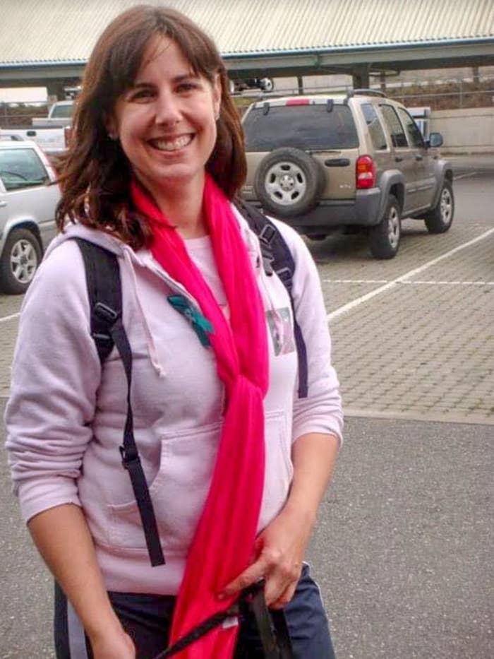 The author learned about the symptoms of ovarian cancer a decade before her own diagnosis. In this 2010 photo taken at a Cancer Walk, she wears pink for breast cancer awareness and a small teal ribbon representing ovarian cancer