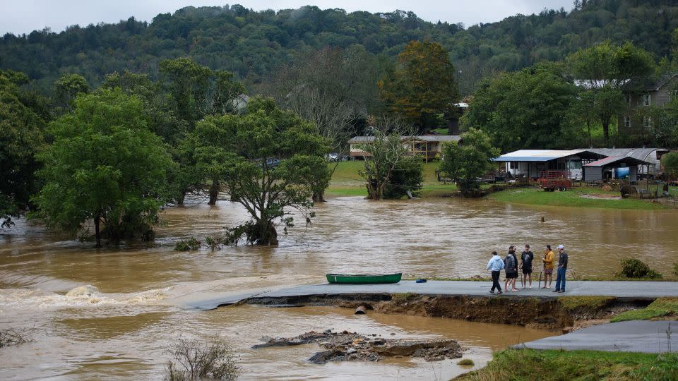 Residents talk after canoeing on the flooded South Fork New River for 32 minutes and landing on a washed-out road on September 27, 2024 in Boone, North Carolina. -Melissa Sue Gerrits/Getty Images