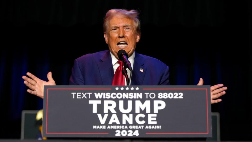 Trump appeared to be distracted by a fly during a rally speech on Saturday. (AP)