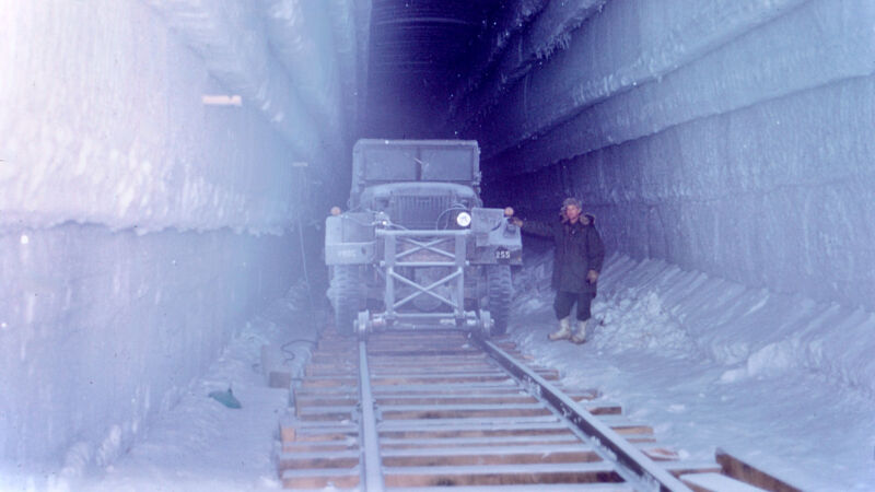 At the American military camp Century on the Greenland ice cap, an army truck equipped with a converted railway wheel drives along 400 meters of track under the snow.