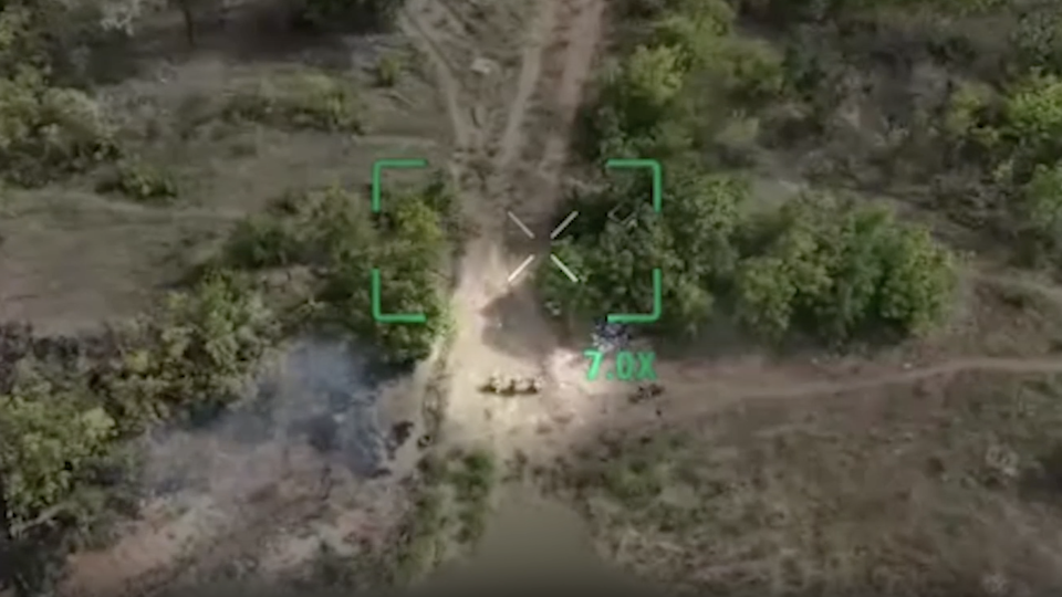 Drone footage from eastern Ukraine last month captured the moment three Ukrainian soldiers staggered up a dusty path and knelt, hands on their heads, in an attempt to surrender. - Obtained by CNN