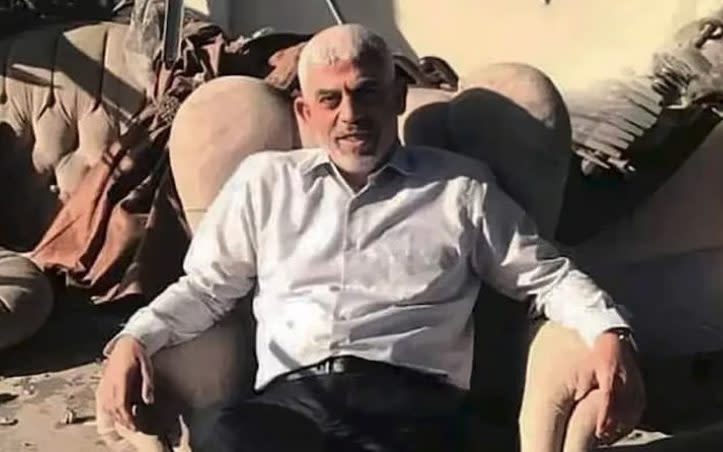 Yahya Sinwar sits defiantly in an armchair after Israel bombs his Gaza home in 2021