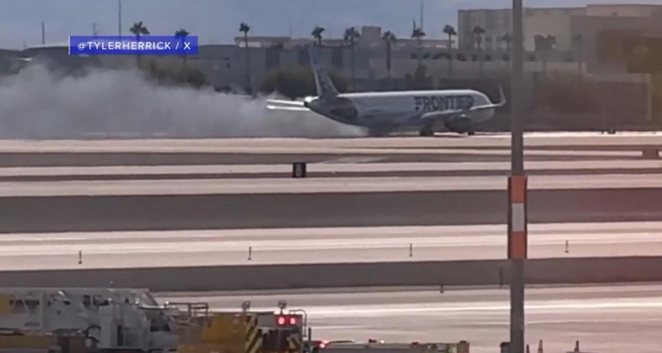 Flames and smoke were visible Saturday afternoon from a plane that made a hard landing at Harry Reid International Airport in Las Vegas. (Courtesy of @Tylerherrick)