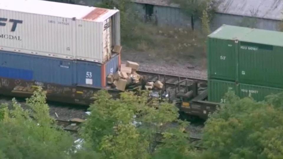 Boxes flow from a freight train