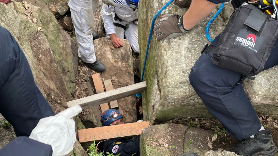 Rescuers had to remove several large boulders to get close enough to her feet to pull her out. - NSW Ambulance