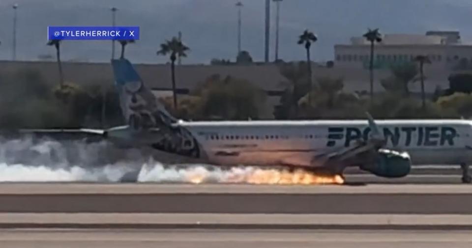 Flames and smoke were visible Saturday afternoon from a plane that made a hard landing at Harry Reid International Airport in Las Vegas. (Courtesy of @Tylerherrick)