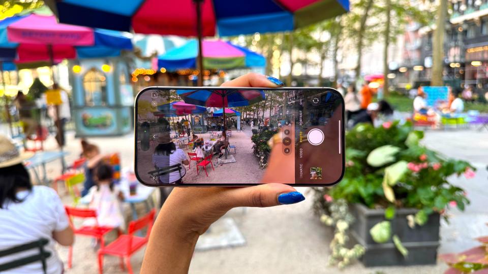 Woman with iPhone 16 Pro Max in Bryant Park