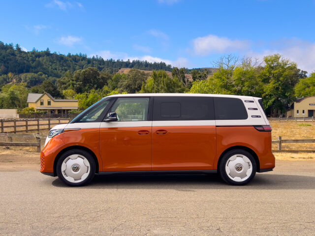 A VW ID Buzz in profile, parked in a rural California town