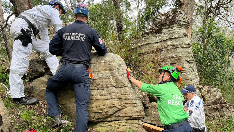 The 23-year-old was walking with friends when she dropped her phone between the rocks. - NSW Ambulance