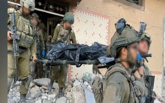 IDF soldiers carry Sinwar's body out of the building