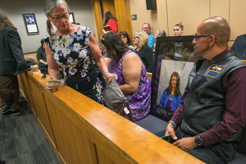 In 2019, Timothy Hoffman, right, sits next to a photo of his daughter Cynthia Hoffman, during Darin Schilmiller's murder arraignment (AP)