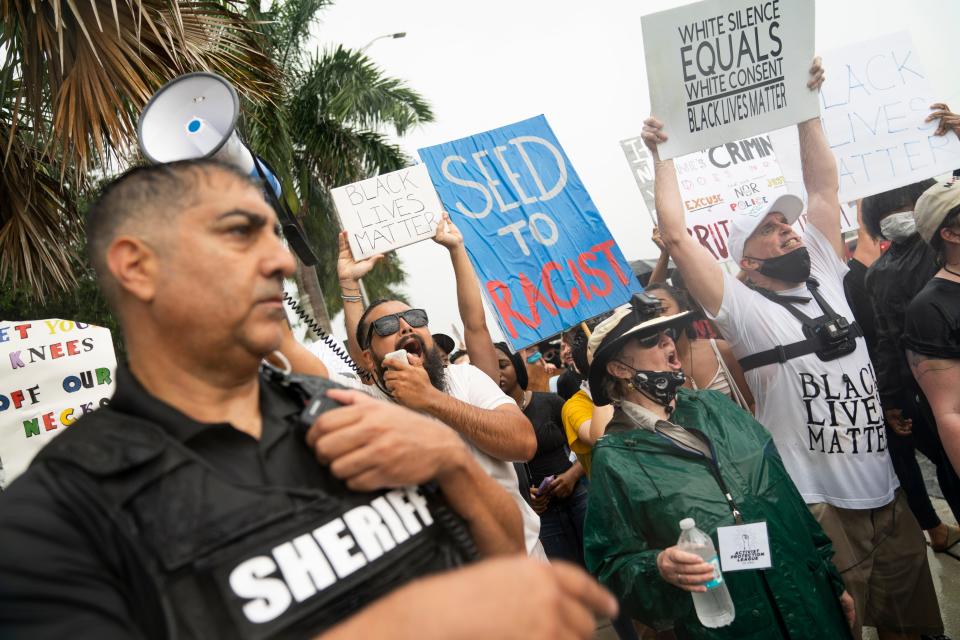 Pro-Black Lives Matter demonstrators chant during a protest at Oakes Farms Seed to Table Market on Saturday, June 13, 2020. The protest was sparked by an inflammatory Facebook post about COVID-19 and the Black Lives Matter movement by Oakes Farms Seed to Table Market owner Alfie Oakes, and was met by a counter-protest organized by Oakes.