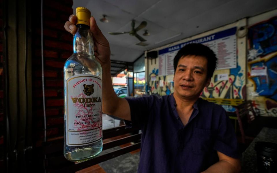 Duong Duc Toan, the manager of Nana Backpackers Hostel, served more than 100 guests on the night of November 12 with free shots of Lao Tiger vodka and Coke Zero