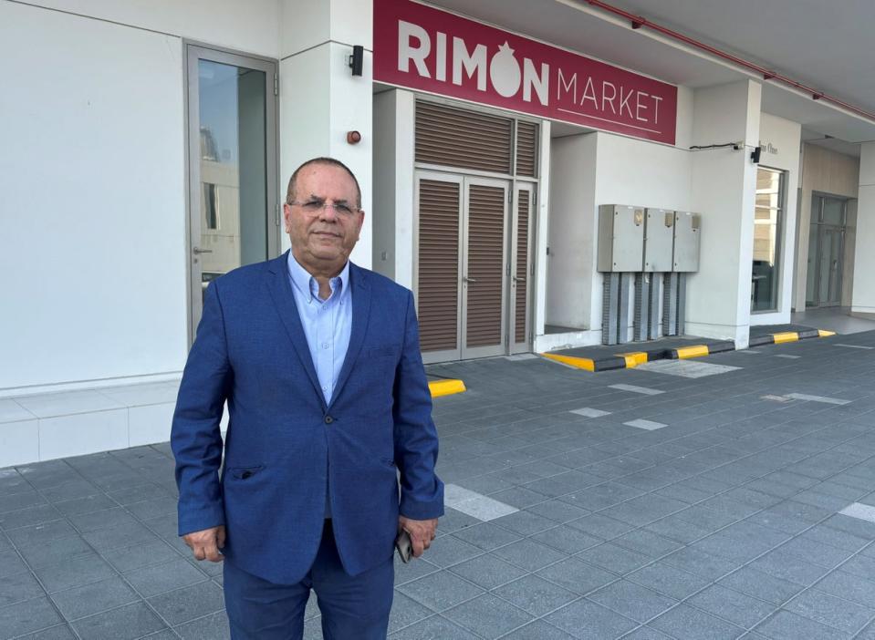 Ayoob Kara outside the Rimon Market kosher store operated by Zvi Kogan (Reuters)