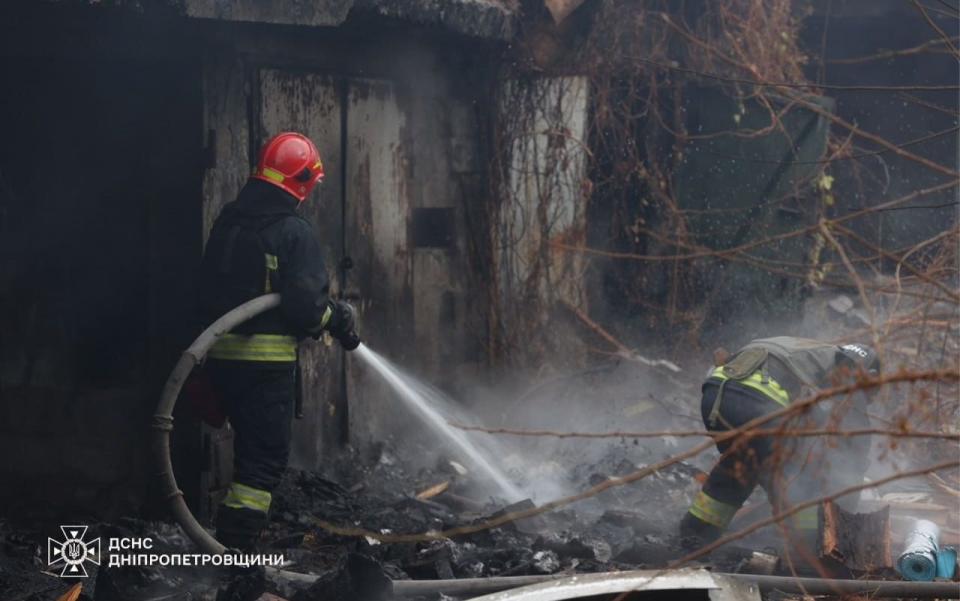 Firefighters work at the scene of the Russian attack on Dnipro