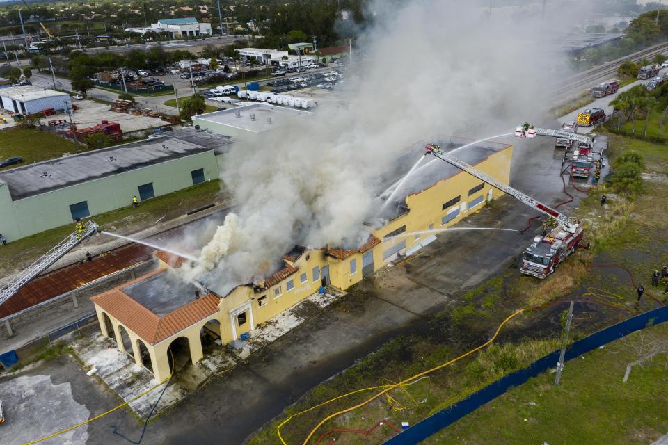 Firefighters spray water on the train depot that caught fire in Delray Beach on February 25, 2020.