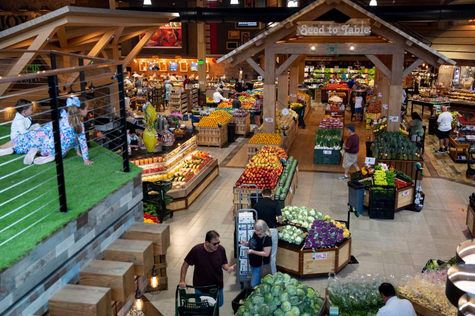 Shoppers browse the produce section at Oakes Farms Seed to Table Market in Naples on Thursday, March 19, 2020.