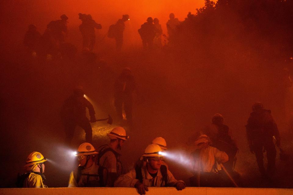 Firefighters battle the Franklin Fire in Malibu, California, on Tuesday. The cause of the wildfire is still under investigation ((AP Photo/Ethan Swope))