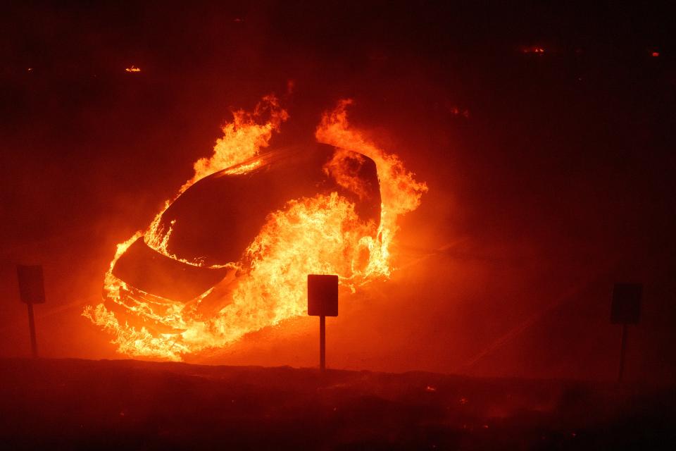 A vehicle burns during the Franklin Fire on the campus of Pepperdine University in Malibu, California, on Tuesday. A shelter-in-place order for campus was lifted ((AP Photo/Eric Thayer))