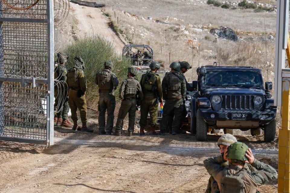 Israeli military vehicles cross the fence as they return from the buffer zone with Syria (AFP via Getty Images)