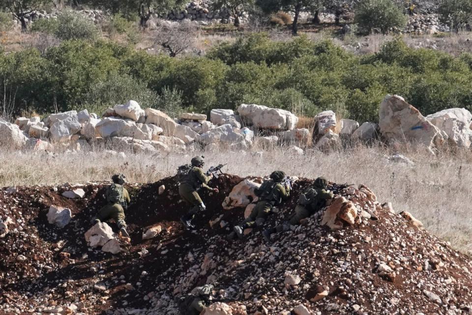 Israeli soldiers take up position near the so-called Alpha Line separating the Israeli-annexed Golan Heights from Syria, in the town of Majdal Shams (AP)