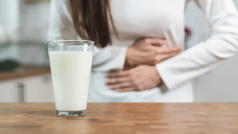 Glass of milk for the person holding the stomach