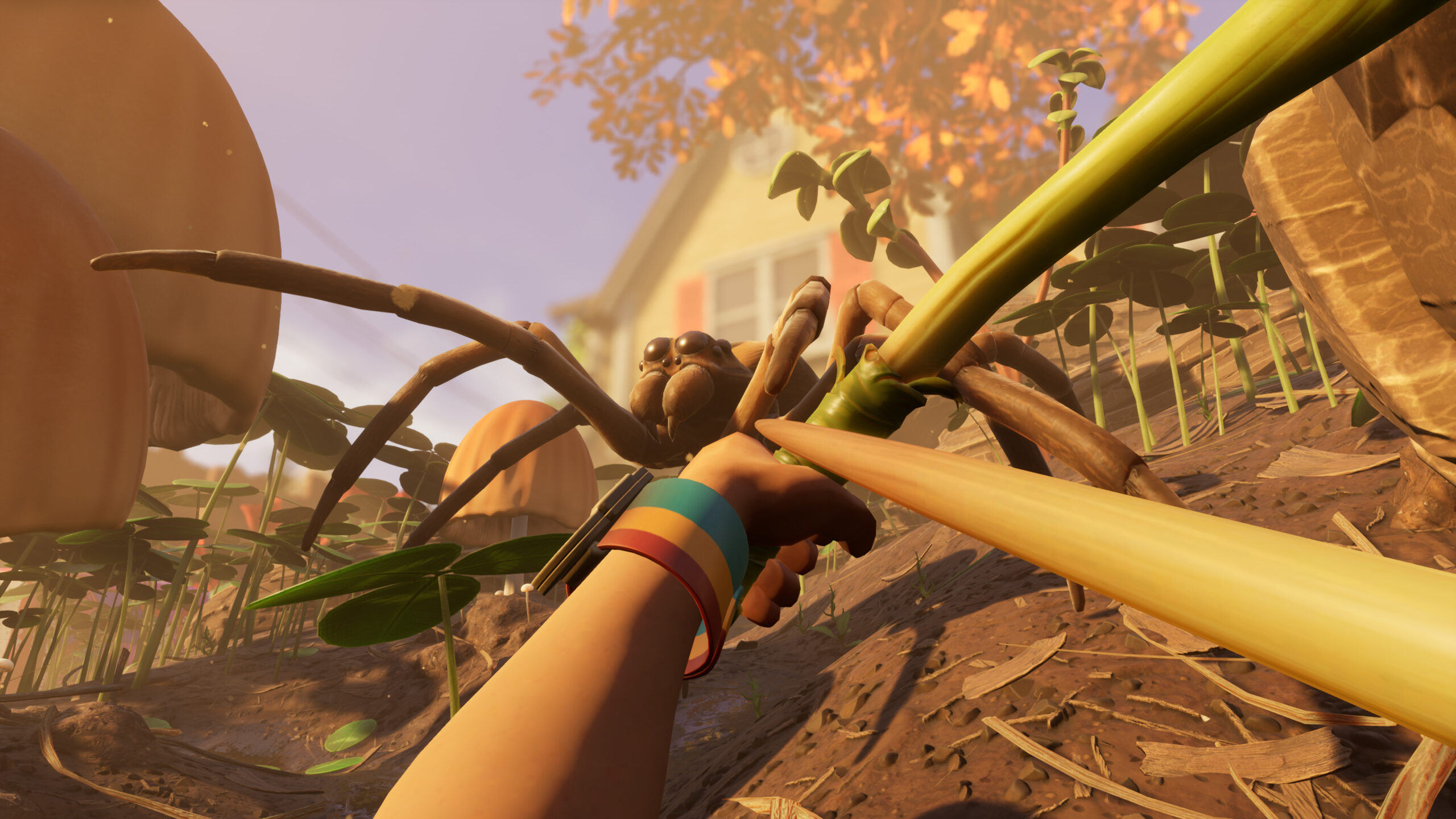 First-person perspective of a suburban house in the background, falling leaves on a nearby tree, and a relatively gigantic spider approaching the player, holding a makeshift bow and arrow, ready to fire.