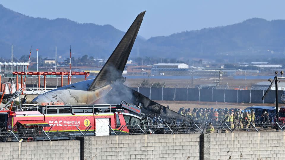 Firefighters and rescue team members work on the runway of Muan International Airport in Muan, South Korea, Sunday, December 29, 2024. (Lee Young-ju/Newsis via AP) - Lee Young-ju/Newsis/AP